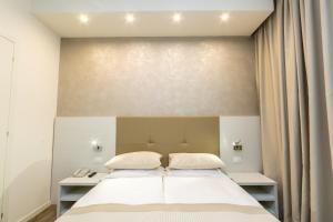 מיטה או מיטות בחדר ב-Hotel Touring