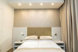 Postel nebo postele na pokoji v ubytování Hotel Touring