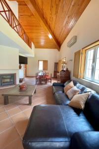 a living room with a couch and a table at Holiday Home Casa dos Loendros by Interhome in Alcácer do Sal