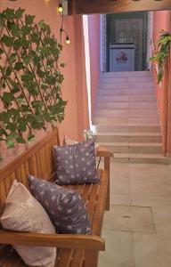 a bench with pillows sitting in front of a staircase at Le house hostel in São Paulo