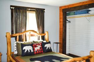 a bedroom with a wooden bed with pillows and a window at Blackhawk in Grand Lake