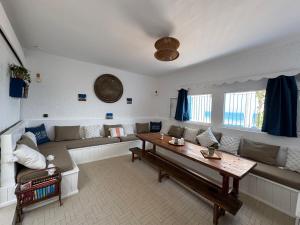 a living room with a couch and a table at Afoulki Home in Taghazout