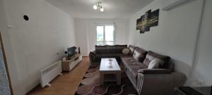 a living room with a couch and a coffee table at Apartman D&A in Brekovica