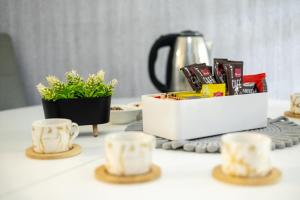 a table with cups and a tea set on it at Apartman D&A in Brekovica