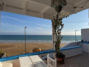 a view of the beach from a pavilion at a beach at Afoulki Home in Taghazout