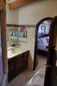 a bathroom with a sink and a room with a bed at Encantó del Mar - Beachfront house in Tijuana +48 photos