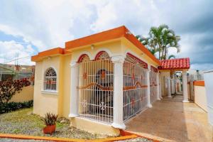 a dog in a cage in a house at Spacious home in Brisa del LLano Higuey in Higuey
