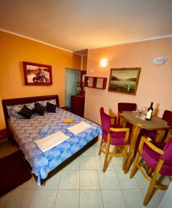 a bedroom with a bed and a table and chairs at Villa Đuričić 200m od mora in Đenovići