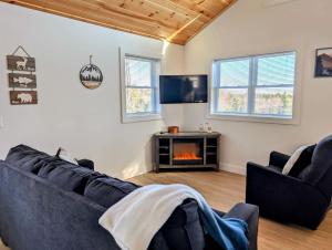 a living room with a couch and a fireplace at Acadia Sunset Fishing Cabin #2 family beach fire pit in Sullivan
