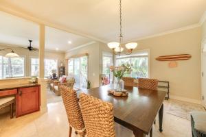a kitchen and dining room with a table and chairs at Walk to Poipu Beaches Koloa Condo with Pool Access! in Koloa