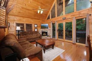a living room with a couch and a table at Yeti Lodge by Avada Properties in Gatlinburg