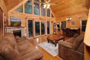 a living room with a couch and a fireplace at Yeti Lodge by Avada Properties in Gatlinburg