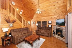 a living room with two couches and a fireplace at Yeti Lodge by Avada Properties in Gatlinburg +29 photos