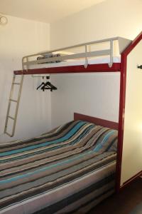 a bedroom with a bunk bed with a ladder at hotelF1 Saint-Die in Saint Die