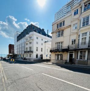 an empty street in a city with tall buildings at Two Top Central Unique Artisan Beach Studios - also separate spa cabin in Brighton & Hove