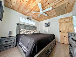 a bedroom with a bed and a ceiling fan at Acadia Sunset Fishing Cabin #2 family beach fire pit in Sullivan +17 photos