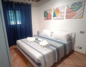 a bedroom with a bed with two towels on it at Casa Anna in Castellina in Chianti