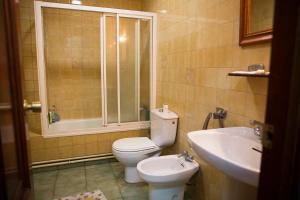 a bathroom with a toilet and a sink at Hostal A Pedra in Vigo