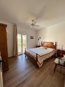 a bedroom with a bed and a sliding glass door at House Casa in Sotillo de la Adrada in Sotillo de la Adrada