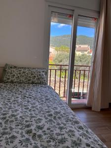 a bedroom with a bed and a view of a balcony at House Casa in Sotillo de la Adrada in Sotillo de la Adrada +23 photos