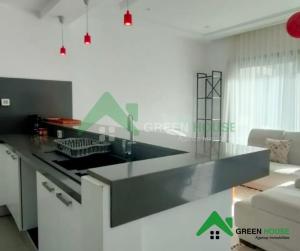 a kitchen with a black counter top in a room at Green Hôte in Gammarth