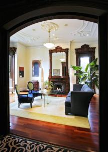 a living room filled with furniture and a large window at The Mansion on Delaware Avenue in Buffalo