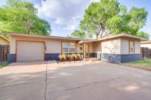 a house with a driveway with a garage at 4 Mi to Dtwn Family Home with Patio in Lubbock in Lubbock