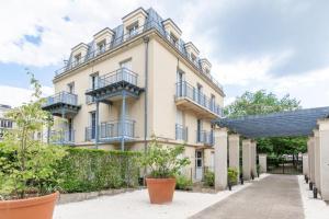 an apartment building with balconies and potted plants at Cosy home Disney in Two min in Chessy