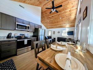 a kitchen and dining room with a wooden ceiling at Acadia Sunset Fishing Cabin #2 family beach fire pit in Sullivan
