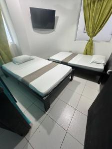 Postel nebo postele na pokoji v ubytování SGH Rodadero Suites