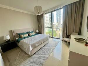 a bedroom with a bed and a large window at Elegant apartment Dubai downtown in Dubai +23 photos