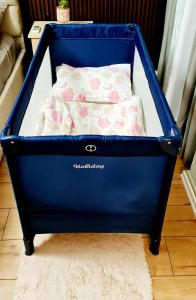 a blue crib with a bed in a room at City Center Beachfront Apartments in Durrës