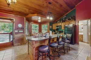 a kitchen with a large island with bar stools at Picabo in Blue Ridge +16 photos