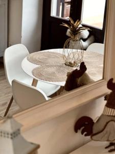 a dining room table in front of a mirror at Contessa Reina in Como