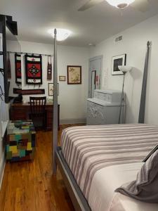 a bedroom with a bed and a desk at Ray's Bucktown Bed and Breakfast in Chicago