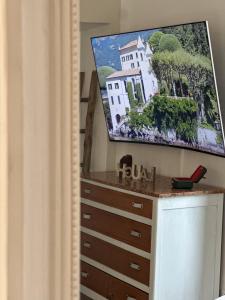 a dresser with a flat screen tv on top of it at Contessa Reina in Como +26 photos