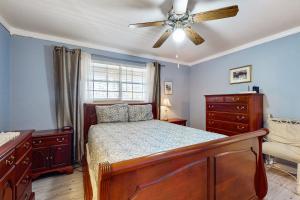 una camera da letto con un letto e un ventilatore a soffitto di Cozy condo with balcony, walking distance to conch house and WIFI a Davis Shores