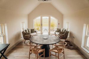 a living room with a table and chairs at Mill Farm House in Chathill