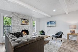a living room with a couch and a fireplace at Affordable 5br Near Route 66 Large Groups #12 in Oklahoma City