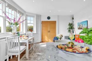 a living room with a table with a plate of food at Slice of Brighton With Seaviews By My Getaways in Brighton & Hove