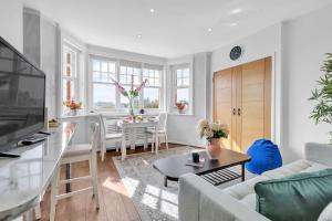 a living room with a couch and a table at Slice of Brighton With Seaviews By My Getaways in Brighton & Hove