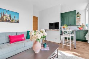 a living room with a couch and a table at Slice of Brighton With Seaviews By My Getaways in Brighton & Hove