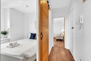 a small bedroom with a bed and a wooden door at Slice of Brighton With Seaviews By My Getaways in Brighton & Hove