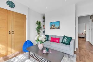 a living room with a couch and a table at Slice of Brighton With Seaviews By My Getaways in Brighton & Hove