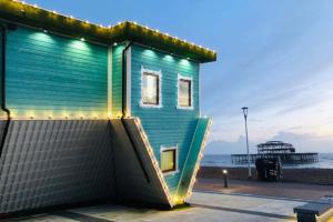 a house with a slide in front of a pier at Slice of Brighton With Seaviews By My Getaways in Brighton & Hove