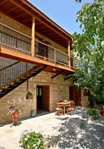 Casa con terraza de madera, mesa y patio en Narkissos Villa, en Kallepia