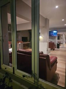 a living room with a couch and a tv at Cape Golf Villa in Cape Town