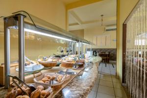 a buffet line with many different types of bread at Hotel Dallas - Penha SC in Penha