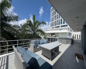 a patio with a table and chairs on a balcony at Dominik luxury penthouse in Cancún