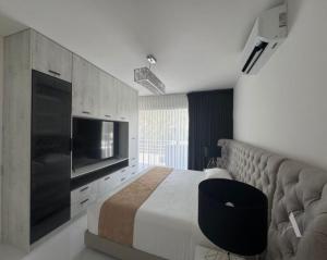 a bedroom with a large bed and a television at Dominik luxury penthouse in Cancún +14 photos